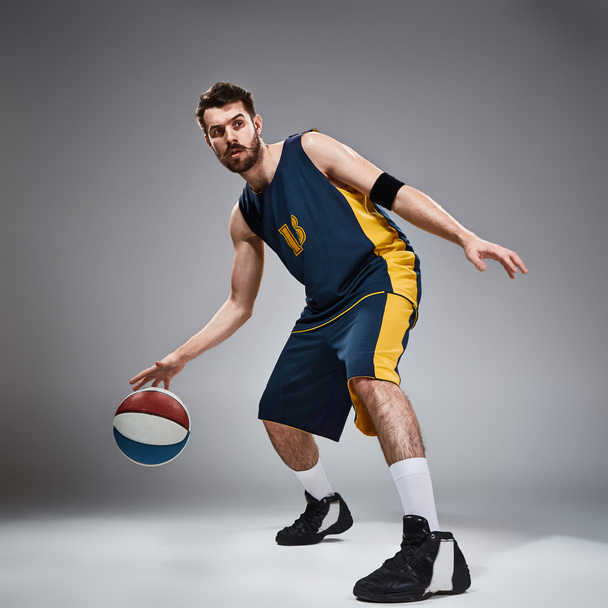 Full length portrait of a basketball player with ball - Фото, изображение
