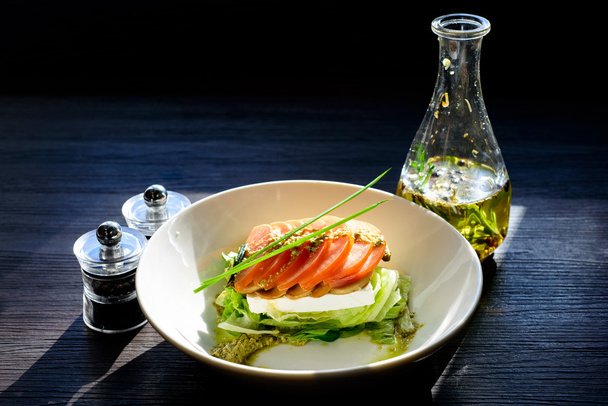 classic Caprese salad with tomatoes, cheese, herbs and sauce - 写真・画像