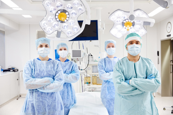 group of surgeons in operating room at hospital - Фото, изображение