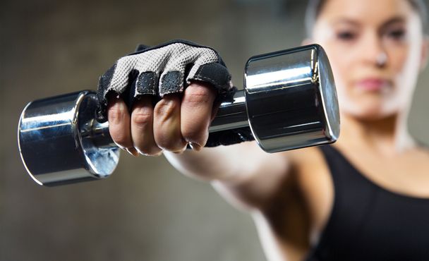 close up of sporty woman with steel dumbbell - Photo, image