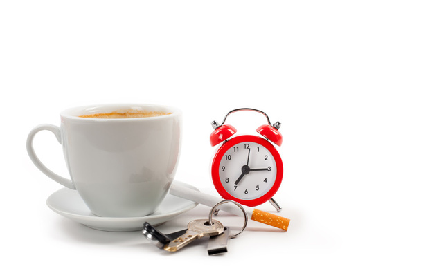 cup of coffee, alarm clock and keys on a white background - Zdjęcie, obraz