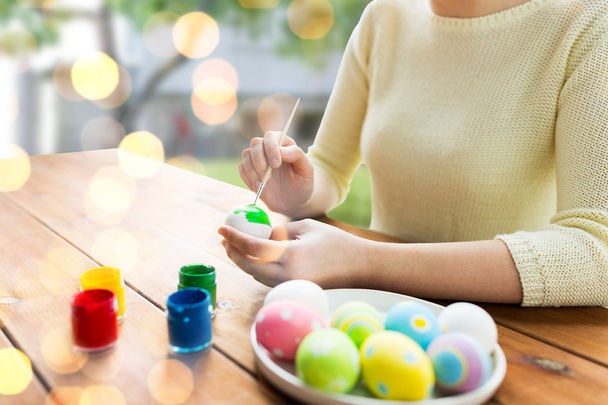 close up of woman hands coloring easter eggs - Фото, изображение