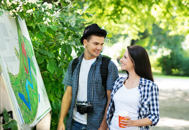 Young couple exploring the park's map - Photo, Image