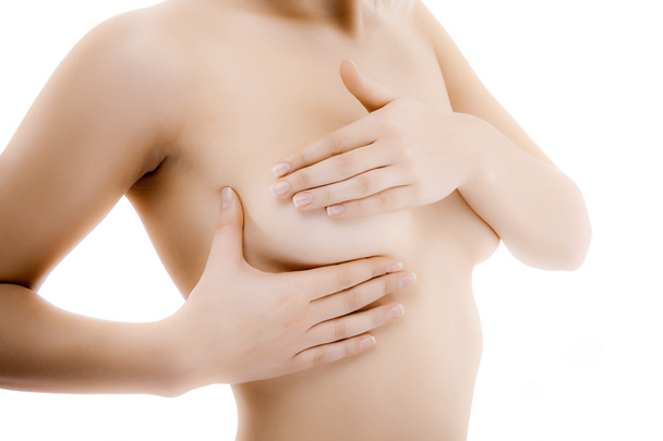 Woman examining her breast - Foto, afbeelding