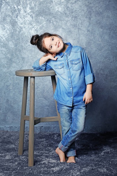 Portrait of little fashion kid girl on gray wall background - Foto, Imagem