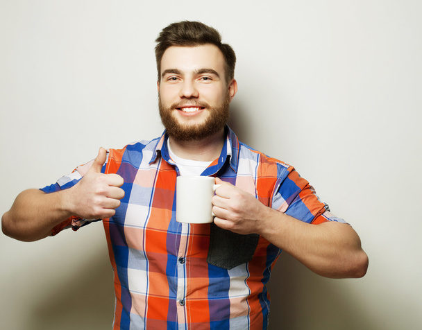 man with a cup of coffee - Zdjęcie, obraz