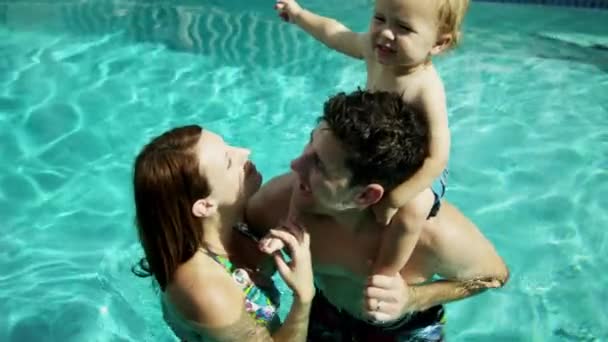 Parents with baby in swimming pool - Footage, Video