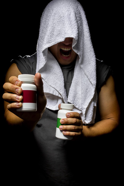 Male with bottles of energy booster supplements - 写真・画像