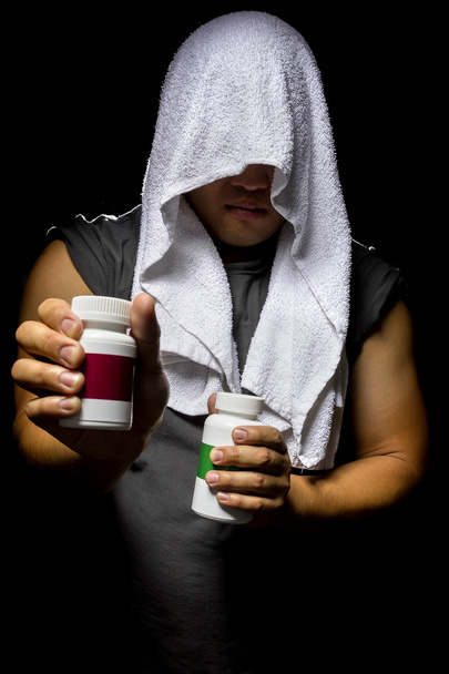 Male with bottles of energy booster supplements - Fotó, kép