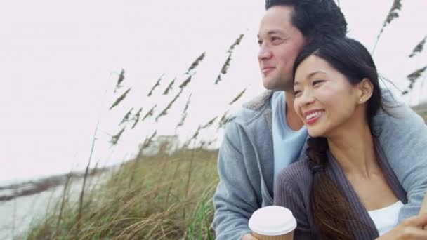 Couple on beach vacation drinking coffee - Footage, Video