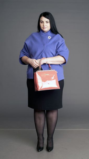 corpulent brunette with a ladies' handbag - Zdjęcie, obraz