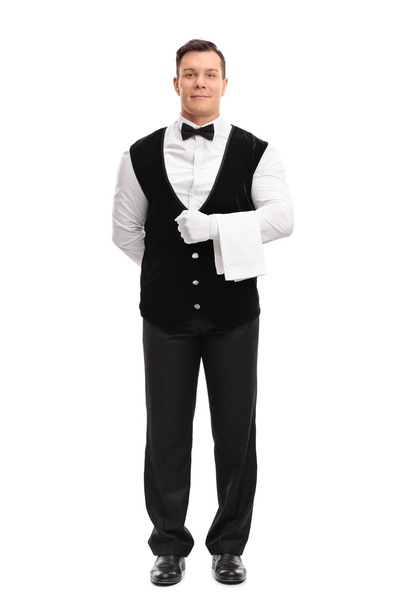Young male waiter holding a white towel  - Foto, afbeelding