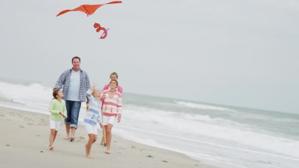 Family having fun with kite on the beach - Footage, Video