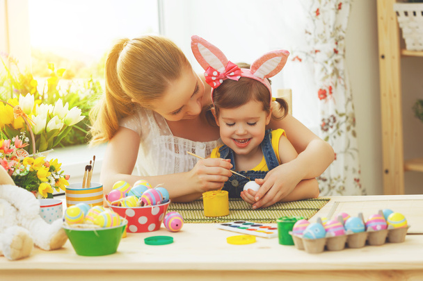 happy family mother and child girl paints eggs for Easter - Fotografie, Obrázek