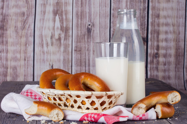 Milk and bagels on a wooden table - Fotoğraf, Görsel