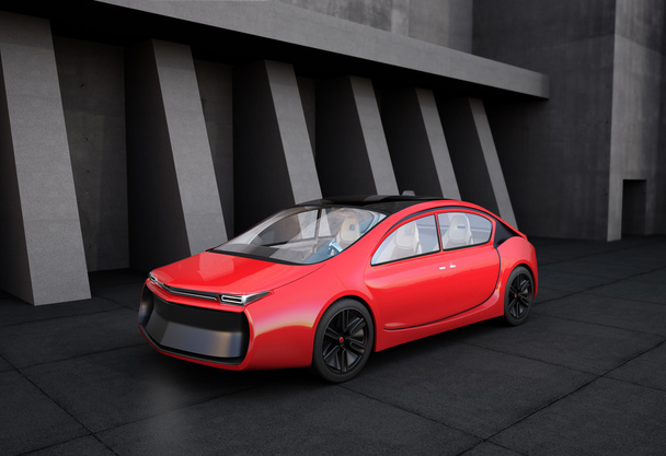 Front view of red electric car in front of concrete building. - Photo, Image