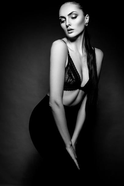 Elegant beautiful girl model with hair gathered in a ponytail. Black and white art photo. - Zdjęcie, obraz