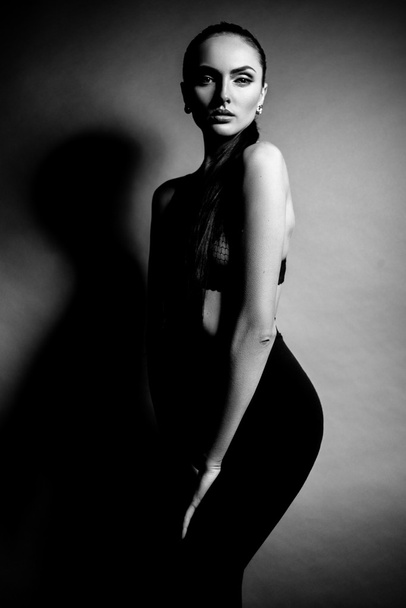 Elegant beautiful girl model with hair gathered in a ponytail. Black and white art photo. - Valokuva, kuva