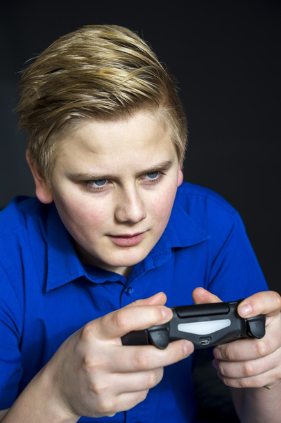 Serious teen playing video games - Photo, Image