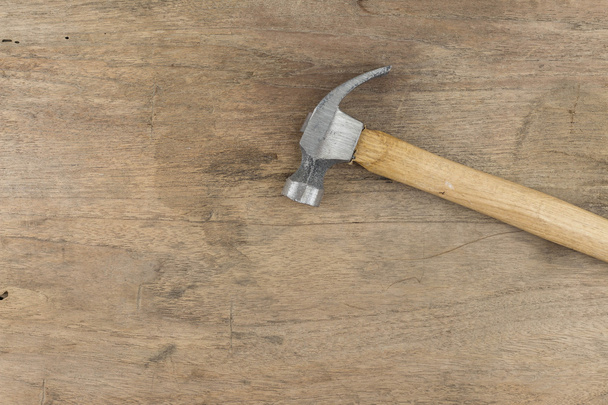 Hammer on wood background - Фото, изображение
