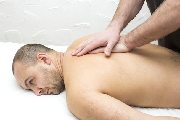man doing sports massage - Foto, afbeelding