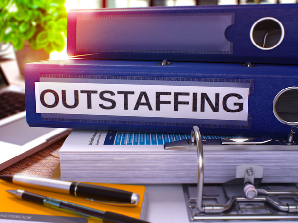Outstaffing on Blue Ring Binder. Blurred, Toned Image. - Foto, afbeelding