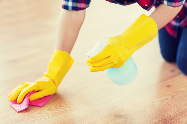 close up of woman with rag cleaning floor at home - Foto, afbeelding