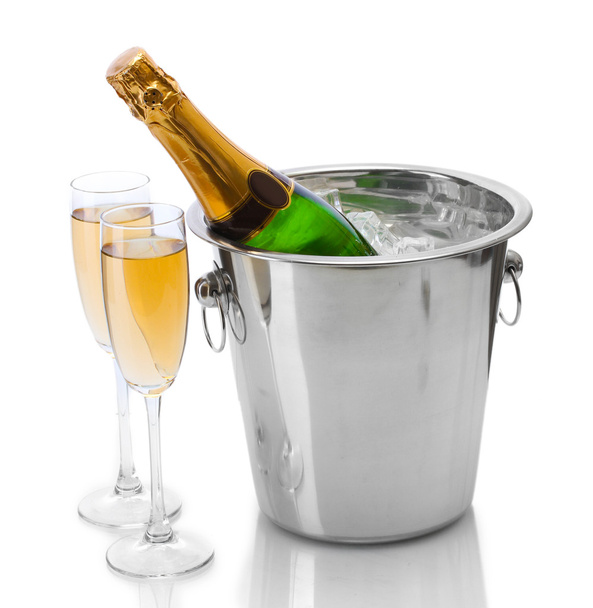 Champagne bottle in bucket with ice and glasses of champagne, isolated on white - Foto, Bild