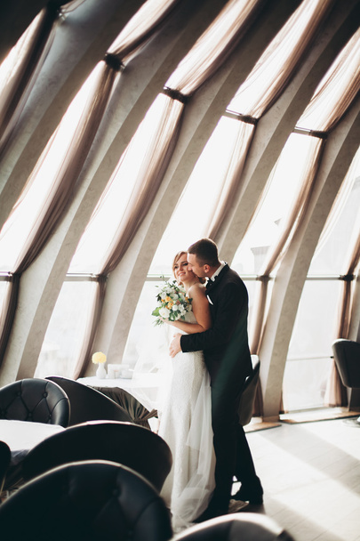 wedding couple is standing and kissing in hotel - Fotoğraf, Görsel