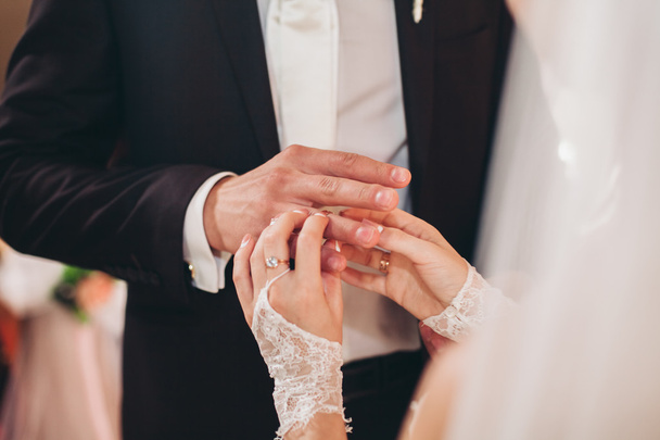 Newlyweds dress wedding ring in the church - Photo, Image