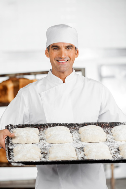 Confident Male Baker Holding Baking Tray - Fotografie, Obrázek