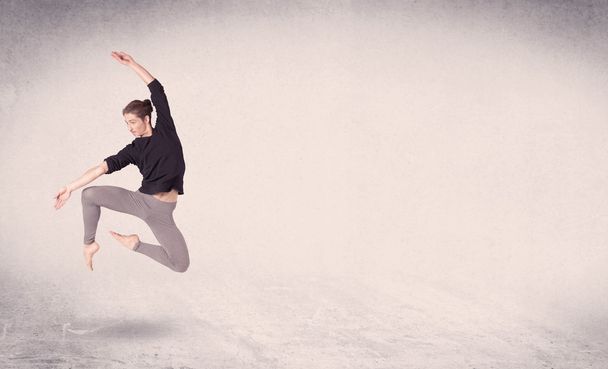 Modern ballet dancer performing art jump with empty background - Zdjęcie, obraz