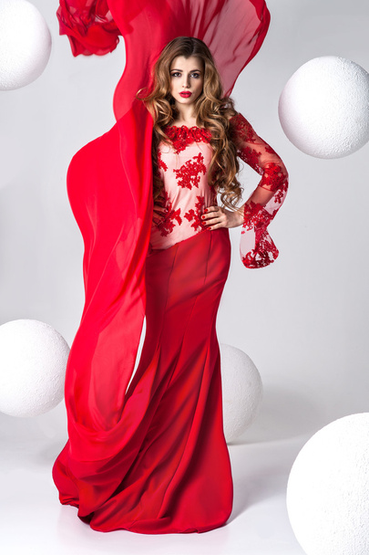 Elegant beautiful woman in red dress. - Фото, изображение