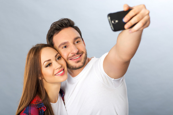 Pleasant young couple making selfie - Фото, зображення