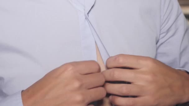 Mans hands button up blue ironed shirt, cuffs. Pan vertical. Indoor. Clothes - Video
