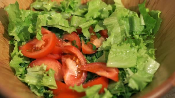 Stir vegetable salad a wooden scapula in the kitchen. - Filmagem, Vídeo