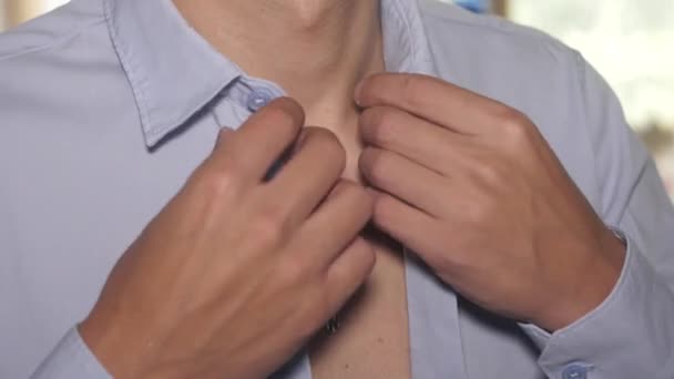Mans hands button up blue ironed shirt. Orthodox cross on neck. Indoor. Clothes - Footage, Video