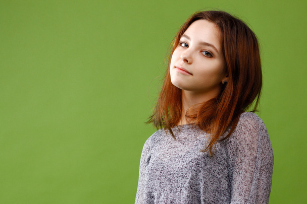 Teenage girl on green background - Foto, imagen