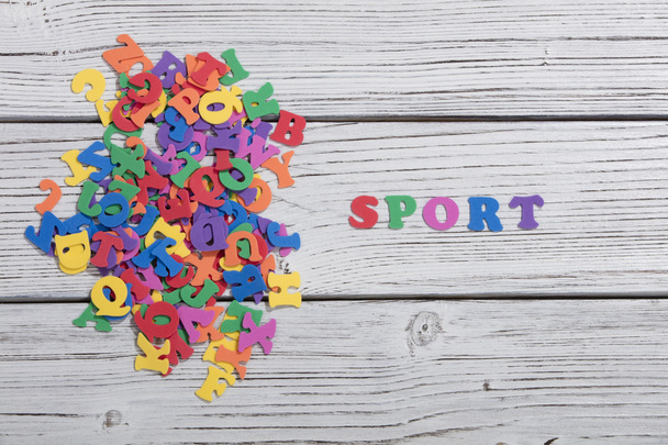 the colorful words sport made with colorful letters over white wooden board - Photo, image