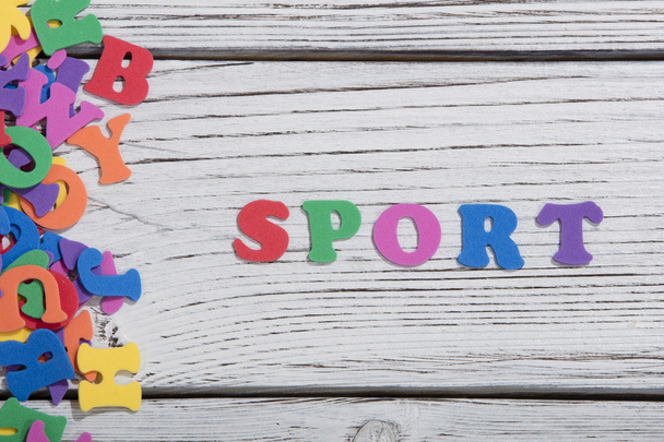 the colorful words sport made with colorful letters over white wooden board - Foto, imagen
