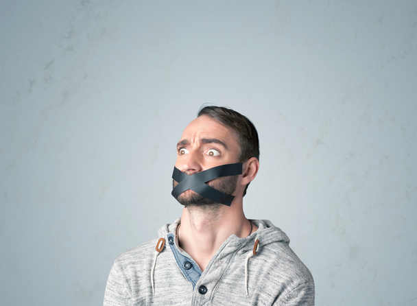 Young man with glued mouth  - Фото, зображення