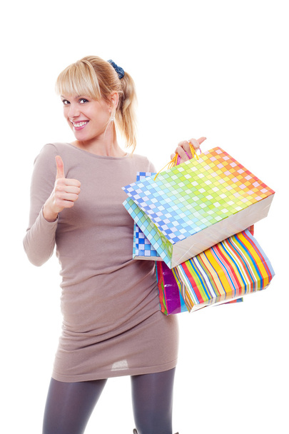 Studio picture of woman with bags showing thumbs up - Foto, immagini