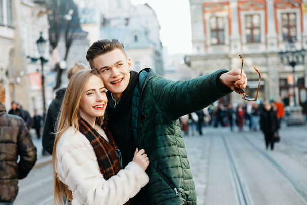 Happy couple standing together on the street - Valokuva, kuva