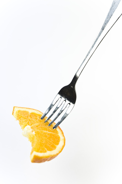 Rebanada de naranja fresca en el tenedor
 - Foto, imagen
