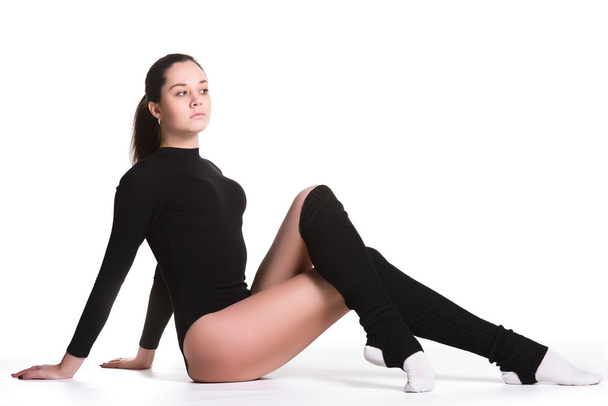 Young cute woman in gymnast suit resting on white background - Zdjęcie, obraz