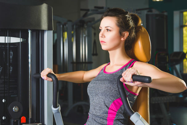 sporty young woman doing exercise at the gym - Photo, Image
