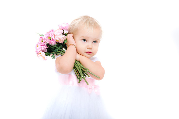 Beautiful little girl with flowers - Фото, зображення