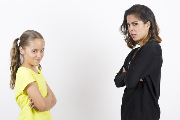 Angry Girl and Mother Over White Background - Zdjęcie, obraz