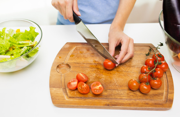 close up of woman chopping tomatoes with knife - Foto, immagini