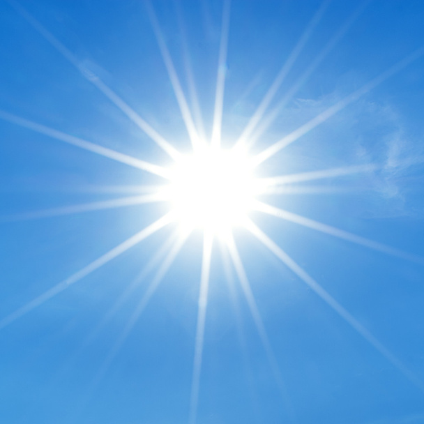 stralende zon op heldere blauwe hemel - Foto, afbeelding